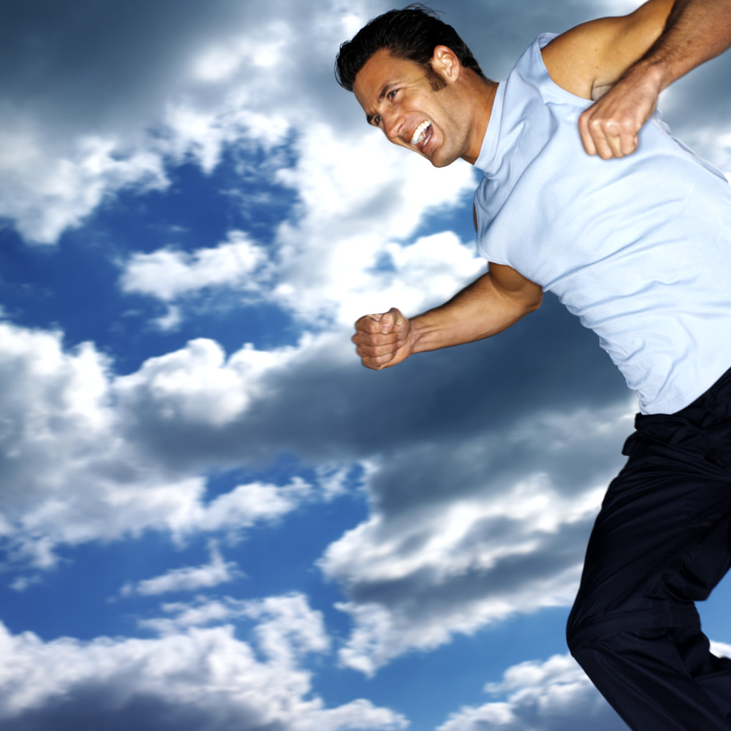 Young Man Jumping Up in the Air Smiling