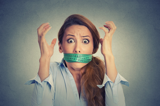 photodune-12689769-frustrated-woman-with-green-measuring-tape-around-her-mouth-xs