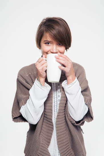 photodune-14209986-pretty-smiling-young-woman-in-knitted-jacket-drinking-tea-xs