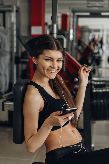 photodune-15532849-beautiful-girl-with-a-phone-in-the-gym-xs