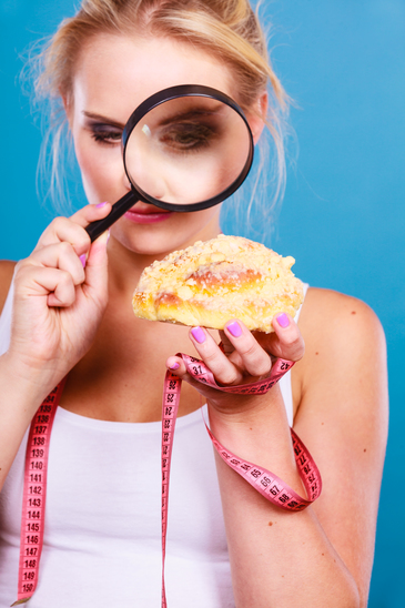 photodune-18133709-woman-with-magnifying-glass-examining-sweet-food-xs