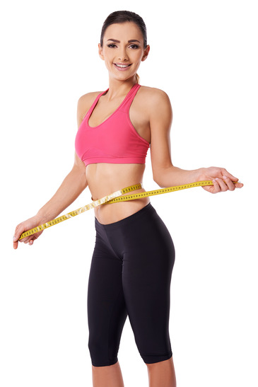 Happy slim woman measuring her waist