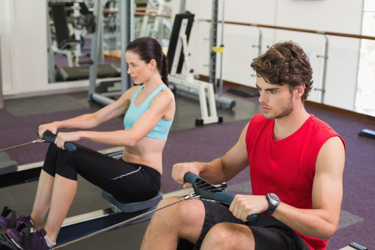 photodune-8601754-man-and-woman-working-out-on-the-rowing-machine-at-the-gym-xs