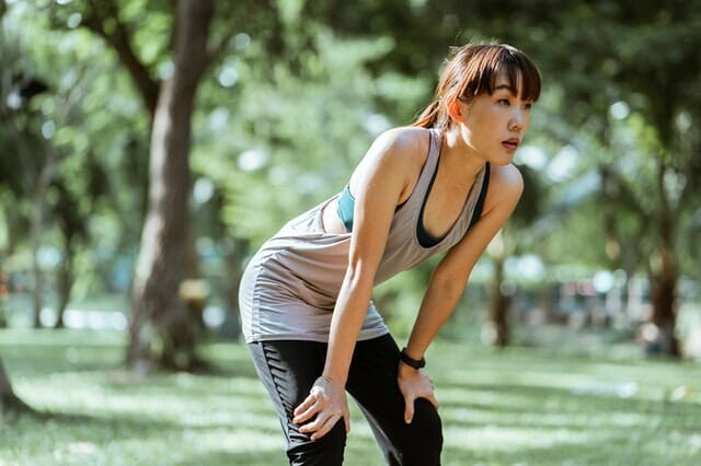 young-asian-sportswoman-having-rest-after-workout-in-park-4426522